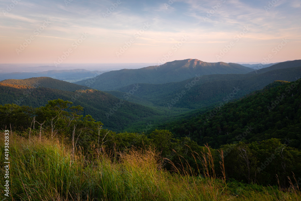 A soft Summer evening looking towards Old Rag Mountain in Shenandoah National Park as light fades away from the rocky summit.