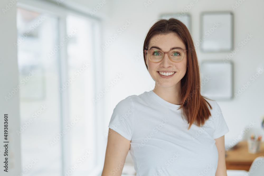 Vivacious happy young woman with a beaming smile Vivacious happy young woman with a beaming smile