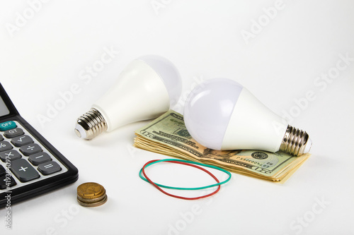 Energy saving lamp and money. Energy efficiency concept.