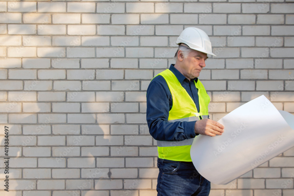 Engineer construction foreman manager at a construction site with blueprints Engineer construction foreman manager at a construction site with blueprints