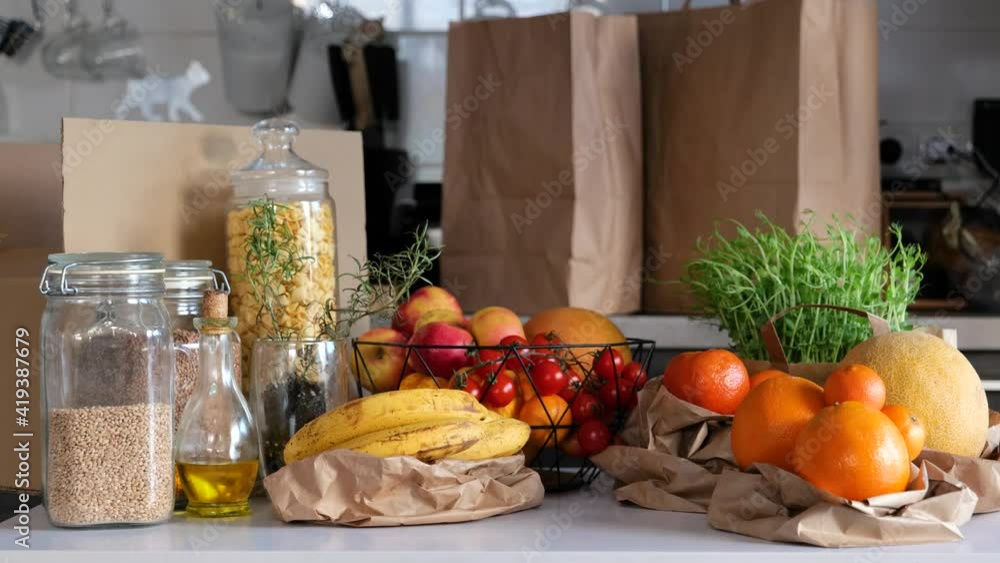 Healthy food groceries in glass jar and eco paper zero waste bags. No plastic and eco friendly concept. Vegan Lifestyle. Reduce Reuse Recycle 4K. New trend alternative buying. Healthy food groceries in glass jar and eco paper zero waste bags. No plastic and eco friendly concept. Vegan Lifestyle. Reduce Reuse Recycle 4K. New trend alternative buying.