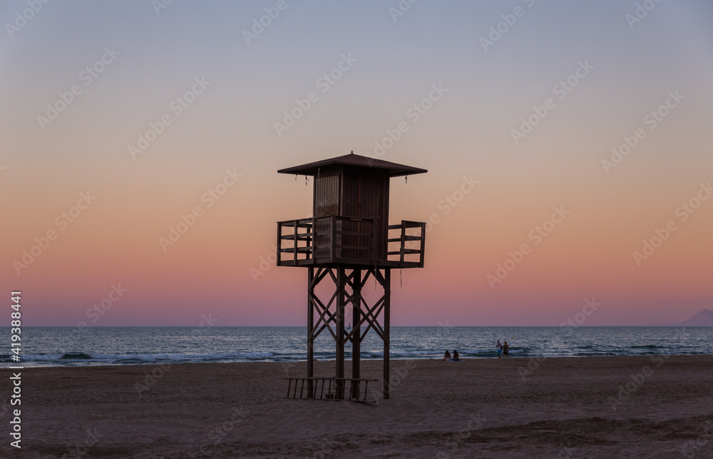 wooden Lifeguard Tower at the beach with sunset lightning wooden Lifeguard Tower at the beach with sunset lightning