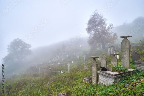 Foggy graveyard in Kubachi village in Dagestan photo