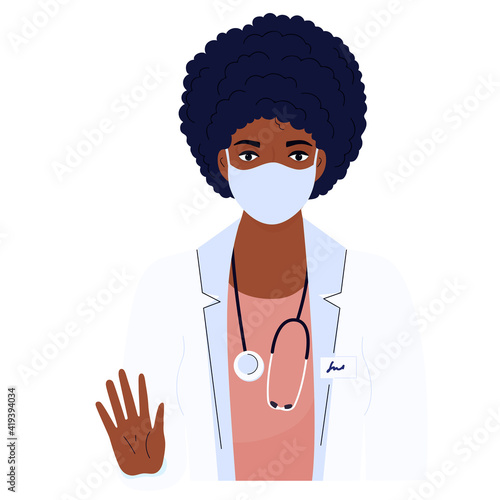 Female doctor. African American woman in a white gown and protective mask. Hospital staff