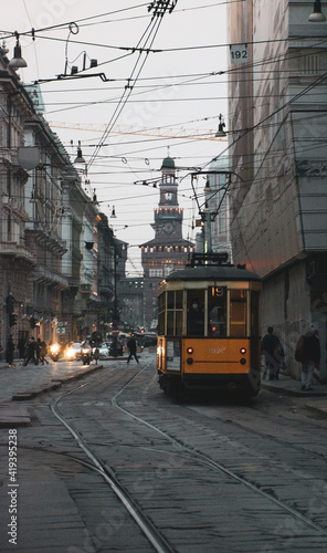 tram in the city center of Milan with castle in the background