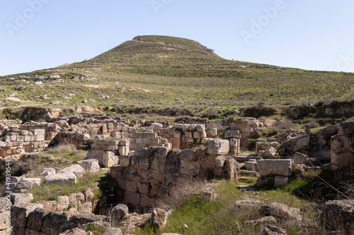 The ruins of outer part of the palace of King Herod, against the background of the filled artificial hill in which they are located the palace of King Herod - Herodion,in the Judean Desert, in Israel