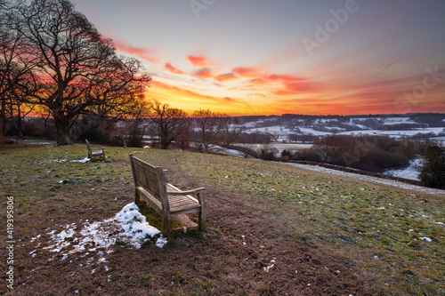 Wooden benches overlooking High Weald landscape on icy winter sunrise, Burwash, East Sussex, England, United Kingdom, Europe