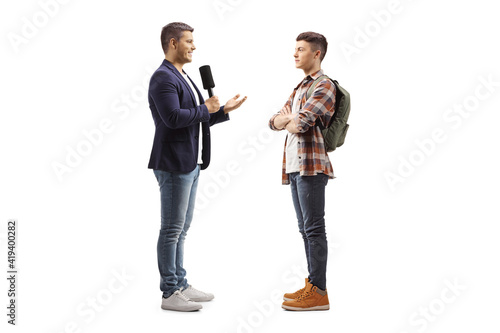 Man with a microphone talking to a male student