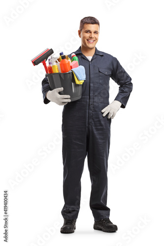 Full length portrait of a janitor holding a bucket with cleaning supplies