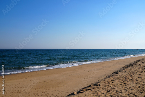 empty sandy beach  sea horizon and clear sky