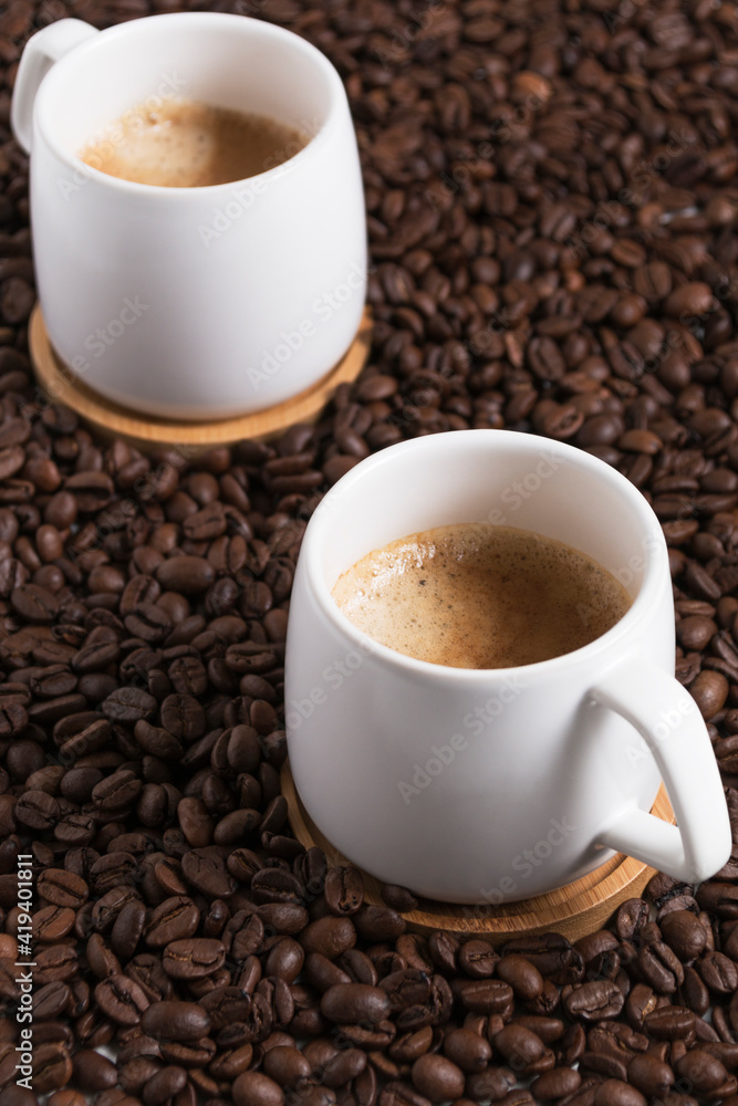 Fototapeta premium two cup of coffee on the background of coffee beans. close up