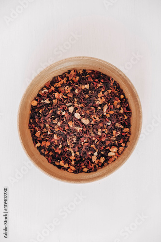 Dry fruit tea in a wooden plate on a white background. Top view. Copy, empty space for text