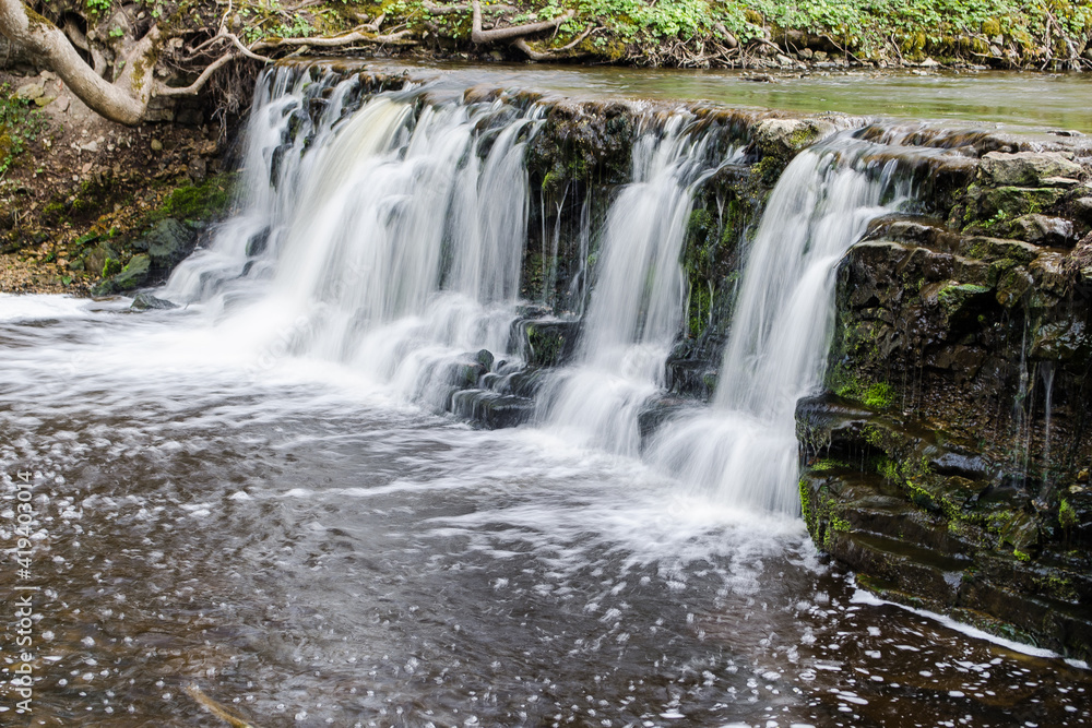 Long exposure waterfall on small river Ivande in Renda, Latvia