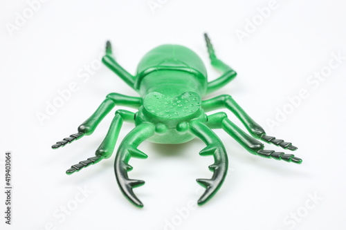 plastic toy horned rhino beetle on a white background close-up 