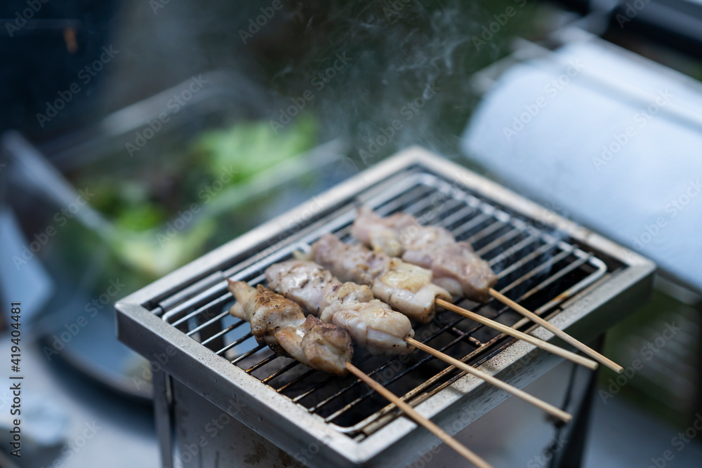 Yakitori chicken grill on mini stove at outdoor camping