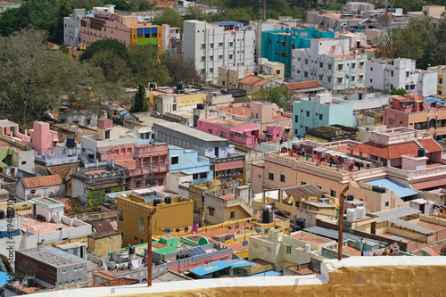 Aerial view of the colourful housing in the centre of the city of Trichy in Tamil Nadu state, India, with lines of washing on many rooftops drying in the sunshine