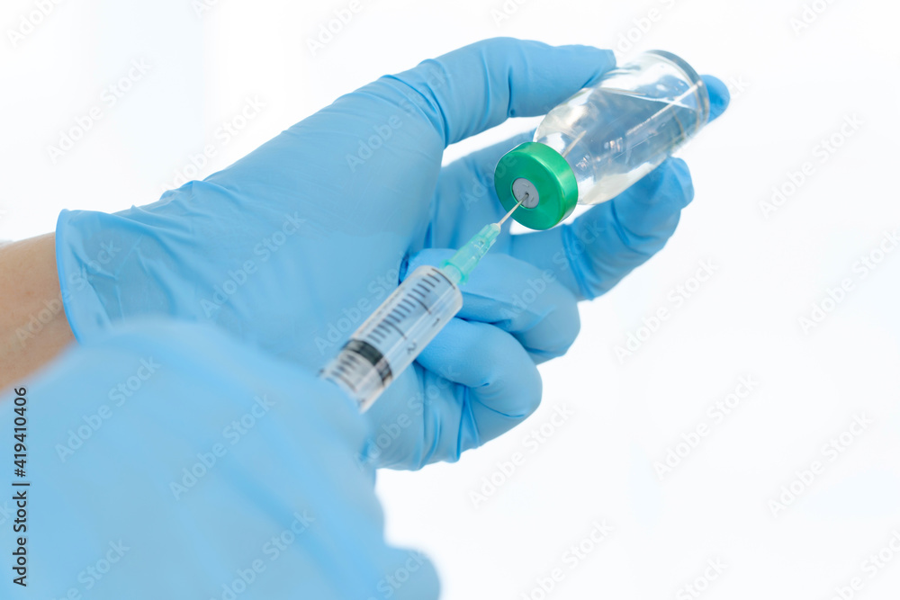 Close up vaccines fight against virus, doctor or scientist in laboratory holding a syringe with liquid vaccines. Close up vaccines fight against virus, doctor or scientist in laboratory holding a syringe with liquid vaccines.