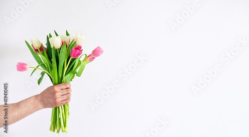 Hand of the man holding beautiful bouquet of tulips. Love and Relationship. Celebrating anniversary  Valentine s Day  Women s Day  Mother s Day  Wedding. Flowers to Minimalistic concept. Copy space