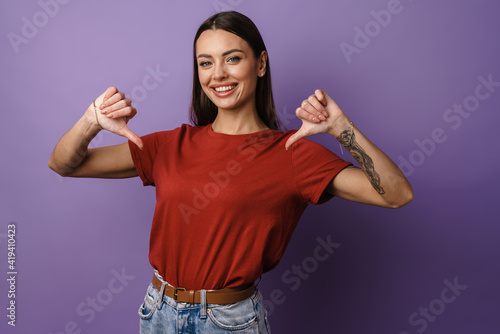 Canvastavla Cheerful young attractive woman pointing fingers at herself