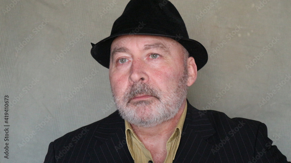 A man in a suit and hat with a smoking pipe in his hand and a ring on his finger represents a gypsy. A man in a suit and hat with a smoking pipe in his hand and a ring on his finger represents a gypsy.