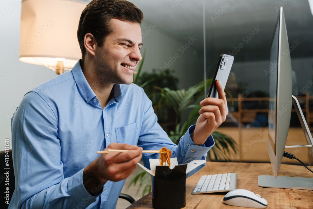 Happy handsome young business man using mobile phone Happy handsome young business man using mobile phone