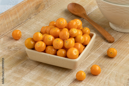 Bowl with fresh orange goldenberries close up photo