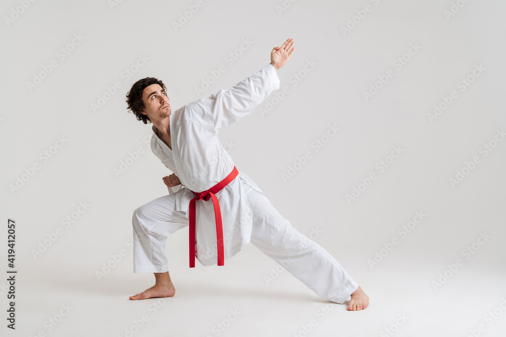 Karate man exercising isolated against Karate man exercising isolated against