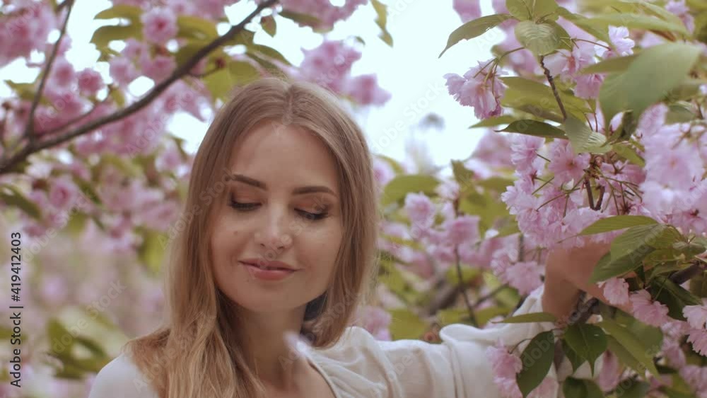 Spring Beauty Portrait of a Woman at Blossoming Sakura Tree on Nature Spring Beauty Portrait of a Woman at Blossoming Sakura Tree on Nature