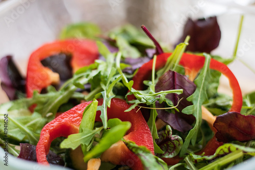 vegetables on a plate. 
chopped peppers in rings, a lot of herbs in a plate. Salad