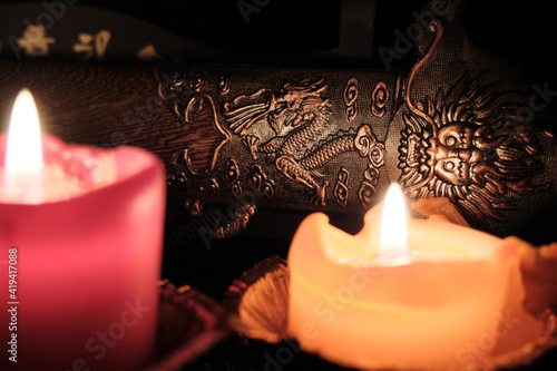 Photography Candlelight illuminates the scabbard of an ancient Chinese sword with dragon