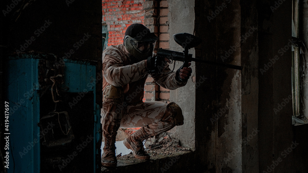 a person with a paintball gun a person with a paintball gun