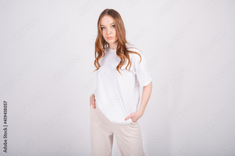 Girl romantic lady oversize t-shirt and loose pants. Young redhead woman isolated on white . Pretty woman layered outfit. Spring summer fashion trend. Casual outfit. Girl romantic lady oversize t-shirt and loose pants. Young redhead woman isolated on white . Pretty woman layered outfit. Spring summer fashion trend. Casual outfit.