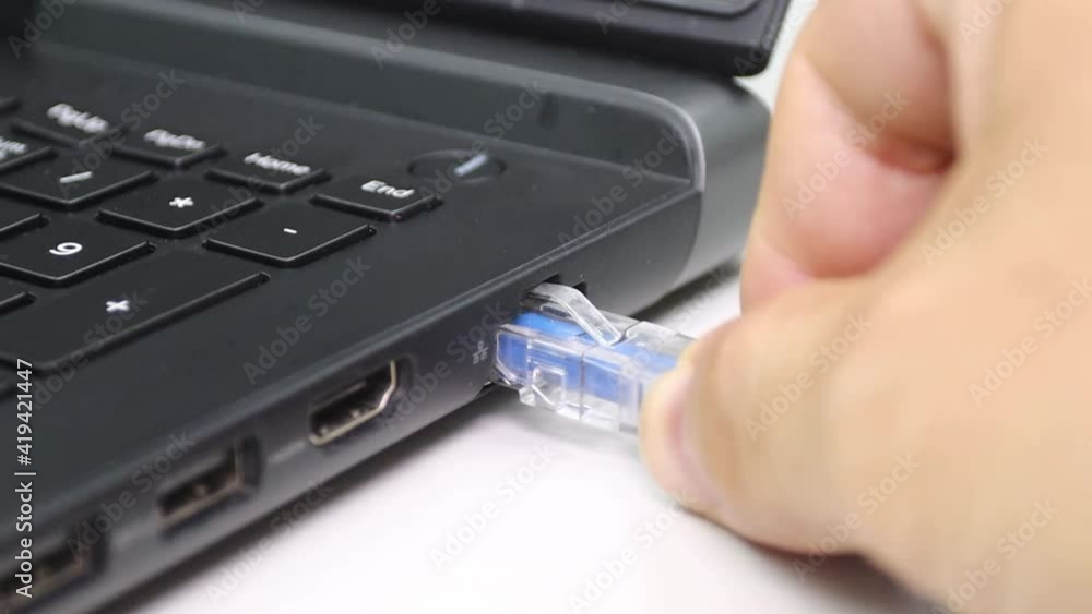 hand man connection blue cable network connection Lan port of a laptop, concept computer connection hand man connection blue cable network connection Lan port of a laptop, concept computer connection