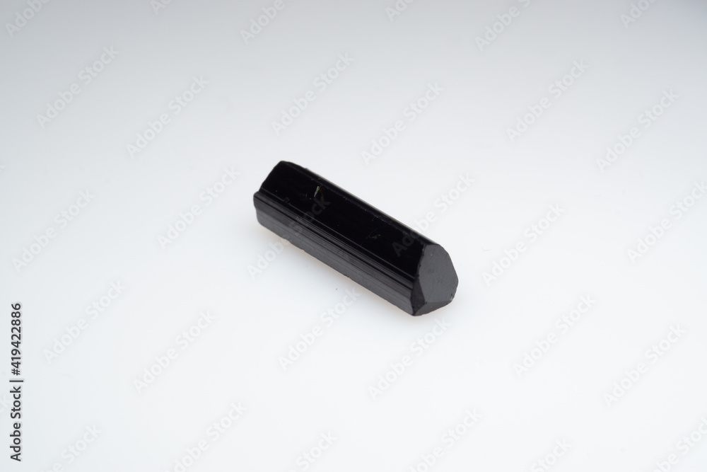 Natural black tourmaline on a white background. Sherl, sherlite Natural black tourmaline on a white background. Sherl, sherlite