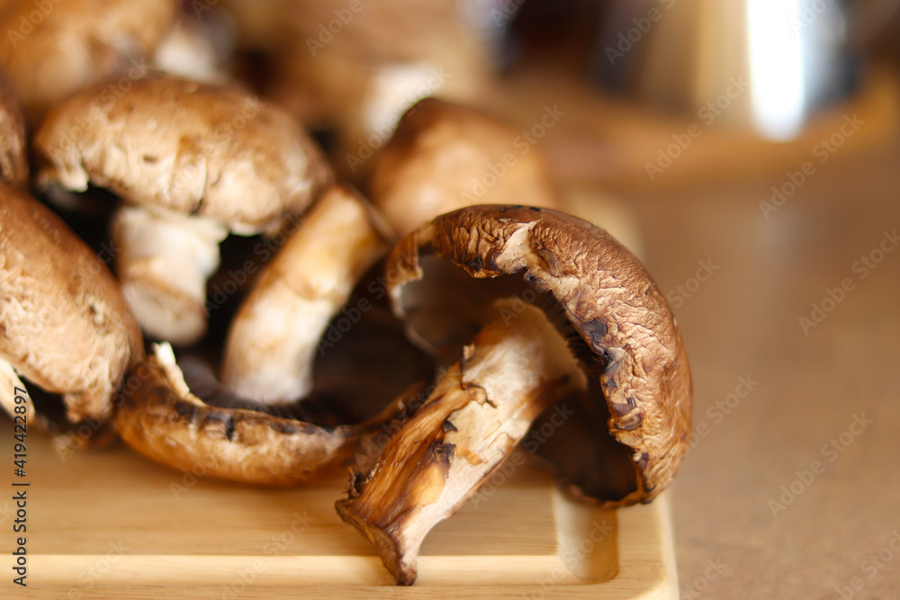 Mushrooms over kitchen wooden board. Healthy food concept. Mushrooms over kitchen wooden board. Healthy food concept.