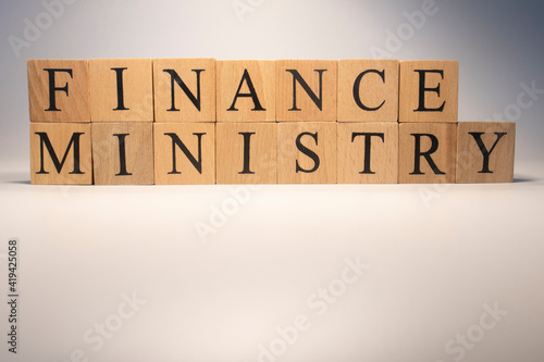 The finance ministry is from wooden cubes. Background from wooden letters. photo