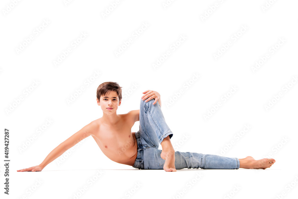 A teenage ballet dancer poses barefoot, isolated on a white background. A teenage ballet dancer poses barefoot, isolated on a white background.