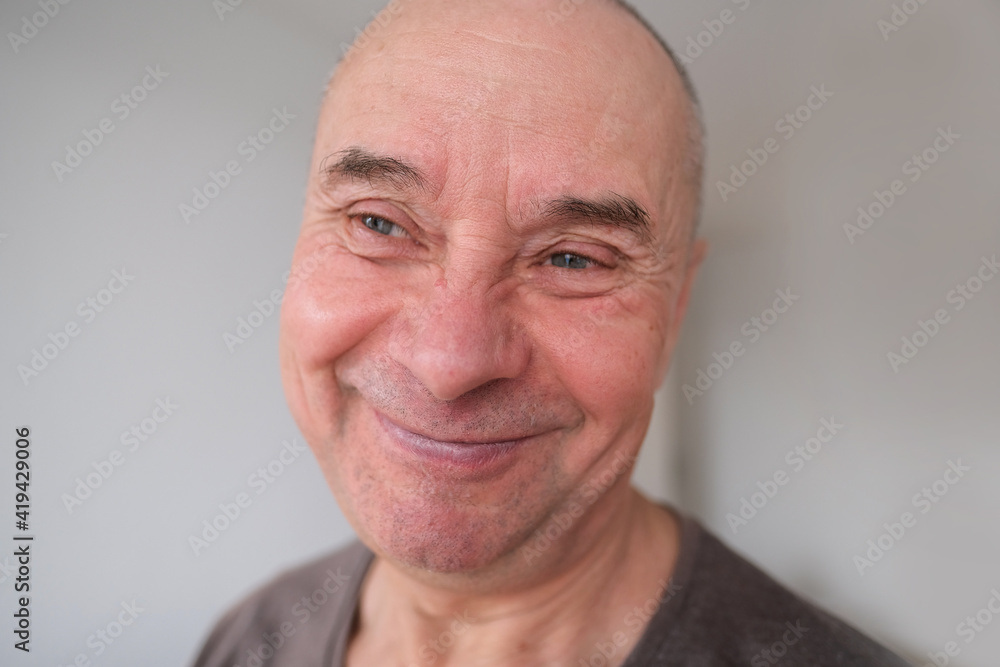 face of European old man close up, wrinkles on aging skin, smiling, good mood concept, cosmetology, age-related changes face of European old man close up, wrinkles on aging skin, smiling, good mood concept, cosmetology, age-related changes