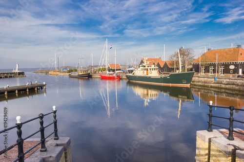 Jetties and ships in the historic harbor of Hindeloopen, Netherlands