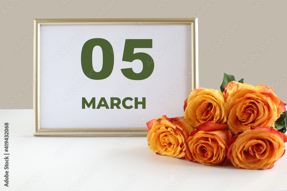 Fototapeta premium day of the month 05 March calendar photo frame and yellow rose on a white table
