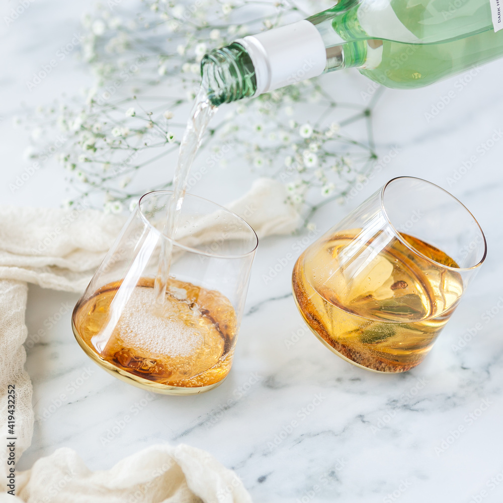 Obraz premium White wine in rolling wine glass 