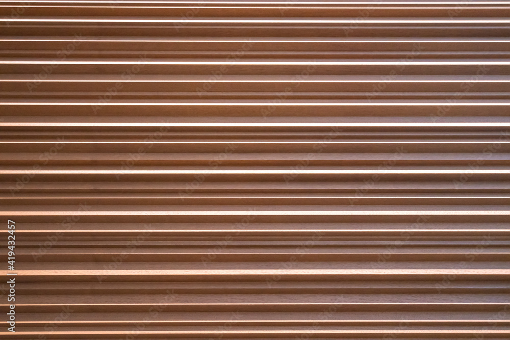 The texture of the wall is made of metal coating of huge aluminum plates of relief shape with horizontal notches. A variety of metal siding close-up The texture of the wall is made of metal coating of huge aluminum plates of relief shape with horizontal notches. A variety of metal siding close-up