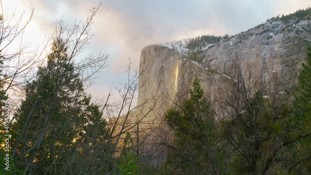 Time lapse of Firefall, a seasonal waterfall illuminated by the late sunlight in Yosemite National Park in California Time lapse of Firefall, a seasonal waterfall illuminated by the late sunlight in Yosemite National Park in California