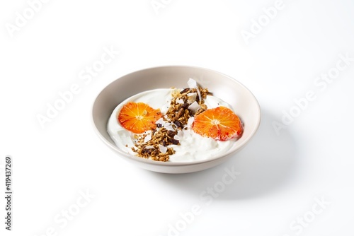 Bowl with yogurt granola and red oranges