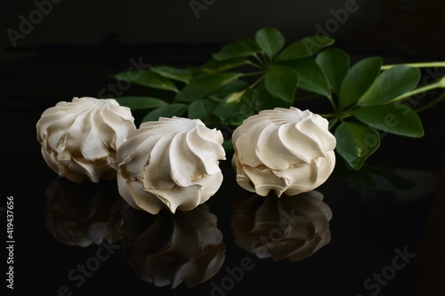 marshmallow and its reflection on ablack glossy background photo