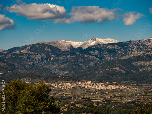 panoramic view of the village of Campanet with the snow covered Puig Major in the Background on the balearic island of mallorca, spain