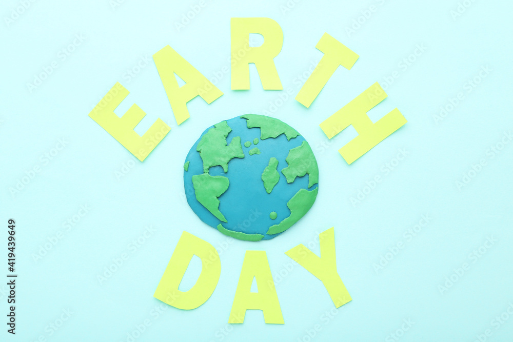 Plasticine planet with text Earth Day on blue background