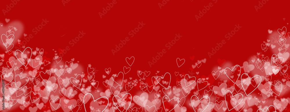Defocused lights on a red background in the shape of hearts. A festive abstract background.