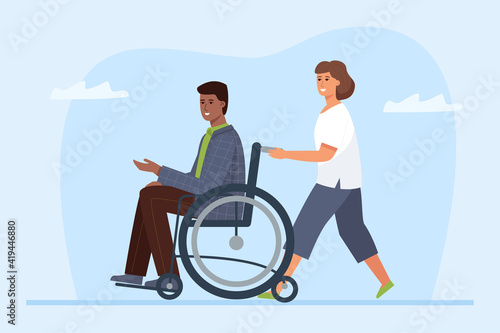 Disabled person in a wheelchair and volunteer. Friendship and support between a paralyzed man and his assistant.