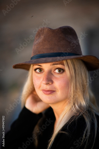 blonde girl in a hat in nature, selective focus © Ekaterina